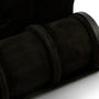 Black suede watch roll with three cylindrical compartments and carrying strap.