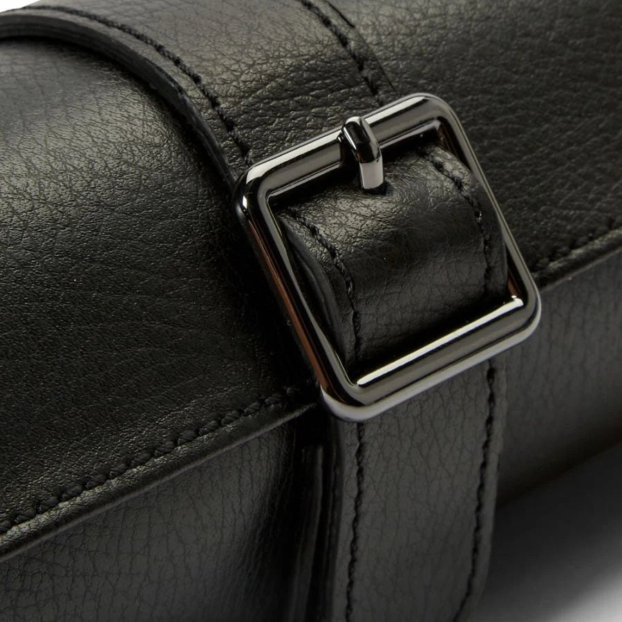 Black leather watch roll with metal buckle closure and stitched compartments for storing multiple watches.