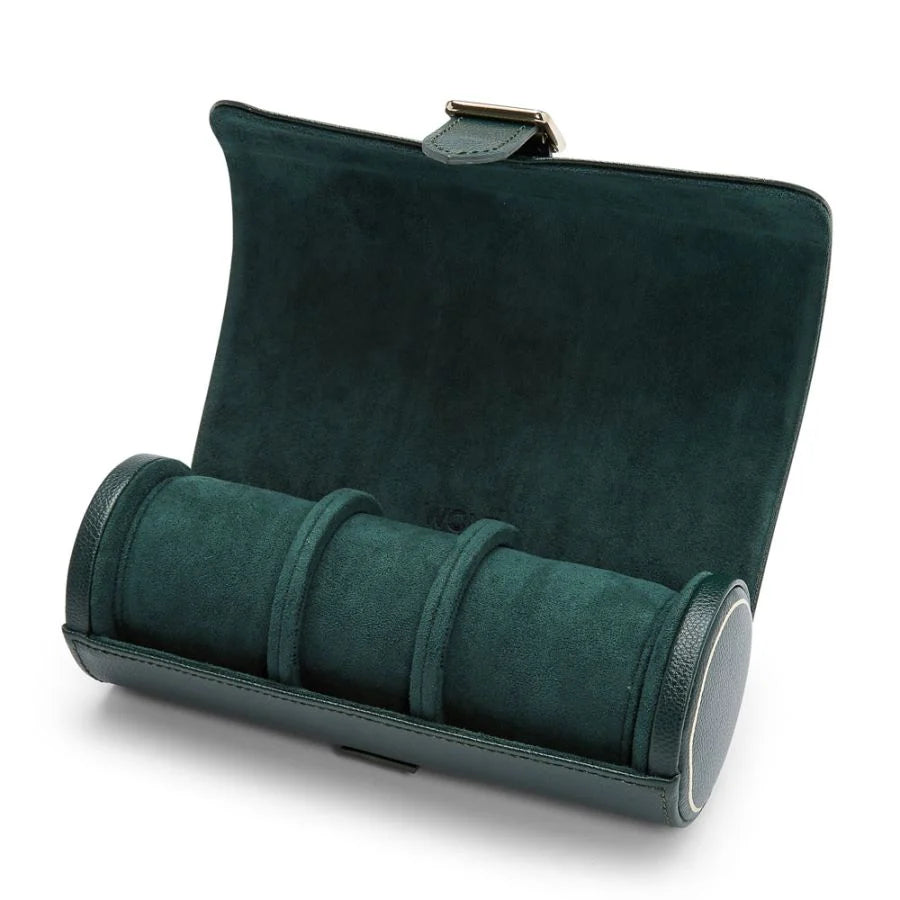 Dark green suede watch roll with three compartments, metal clasp, and leather trim.