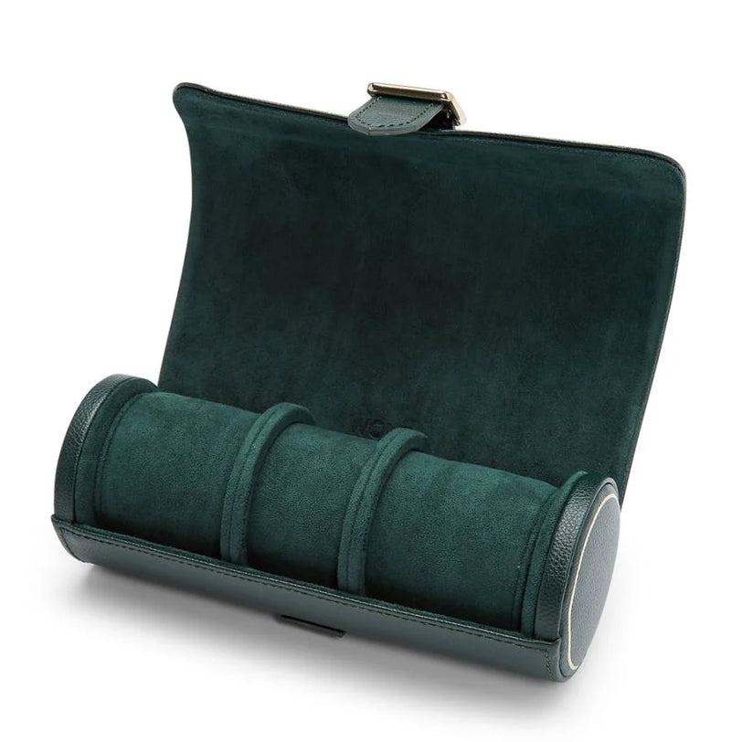 Dark green suede watch roll with three compartments, metal clasp, and leather trim.