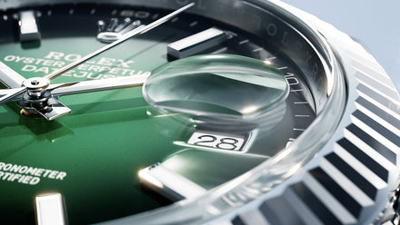Close-up of a Rolex watch with green face and silver accents