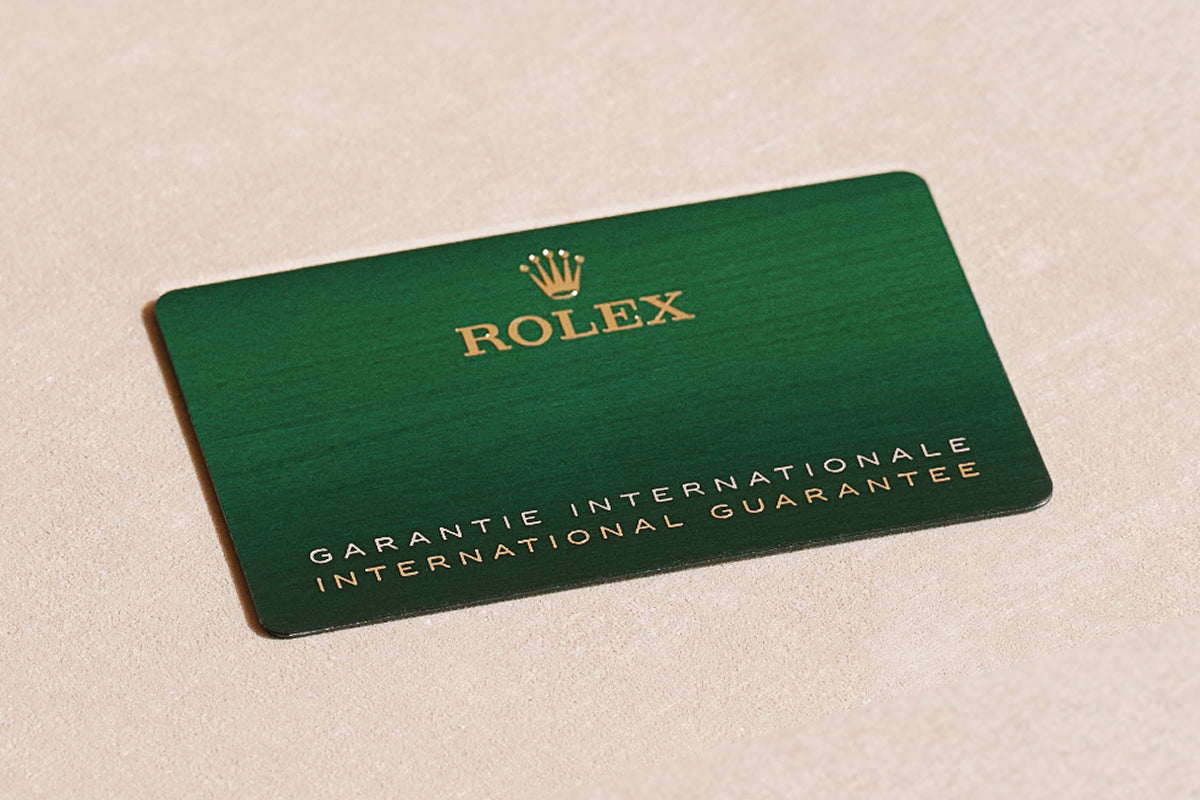 Rolex warranty card on a beige background