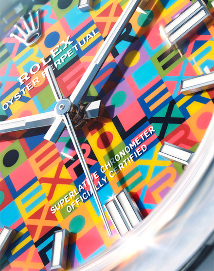 Colorful geometric patterned watch face with 'Rolex' branding