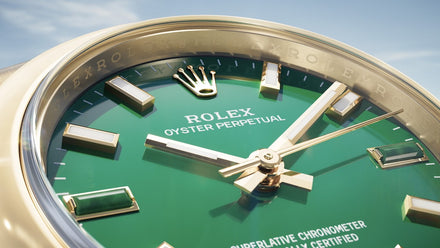 Close-up of a Rolex watch with green face and gold casing against a blue sky.