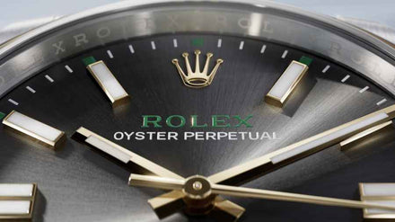 Close-up of a Rolex watch with green face and silver accents